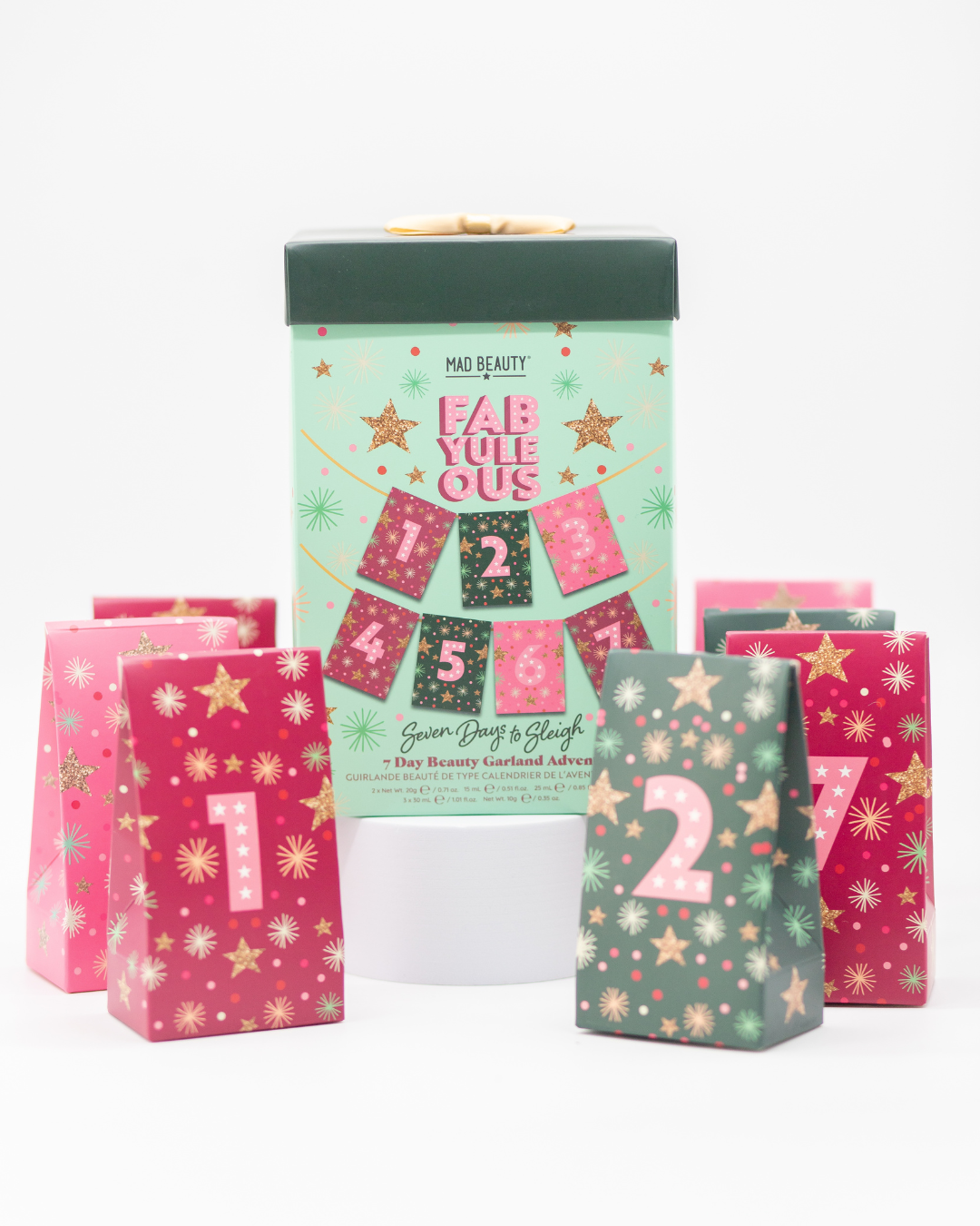 Advent calendar with pink and green packaging on a white background.